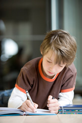 boy writing in notebook